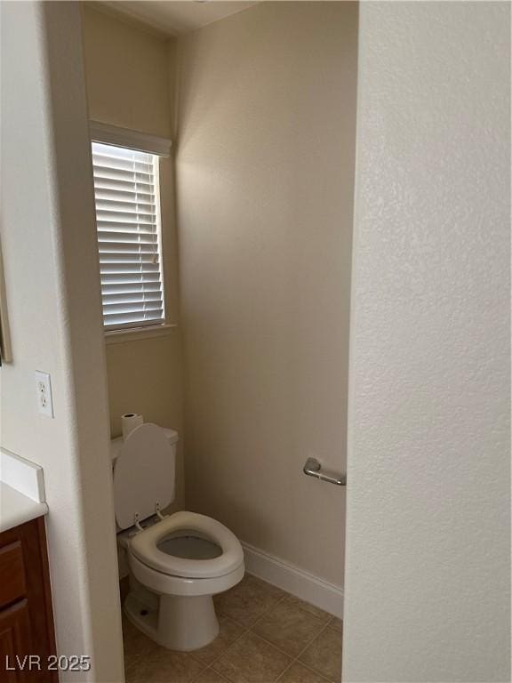 bathroom with tile patterned floors, vanity, and toilet