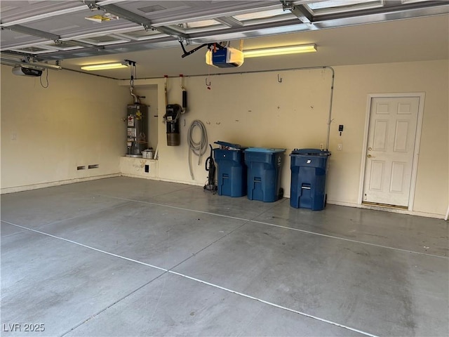 garage featuring a garage door opener and water heater