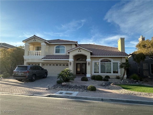 mediterranean / spanish house with a garage