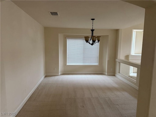 unfurnished dining area with light colored carpet and a notable chandelier