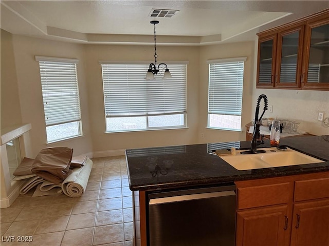 kitchen with stainless steel dishwasher, a raised ceiling, sink, light tile patterned floors, and decorative light fixtures