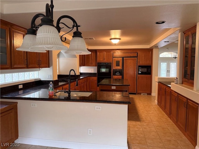 kitchen with sink, french doors, kitchen peninsula, dark stone counters, and black appliances