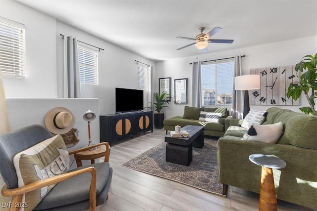 living room with light hardwood / wood-style floors and ceiling fan