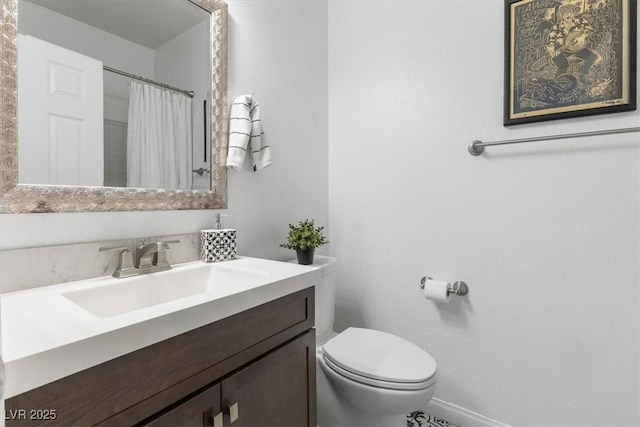 bathroom with toilet, vanity, and a shower with shower curtain