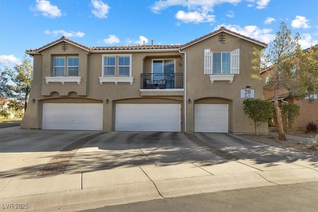 mediterranean / spanish-style home with a garage