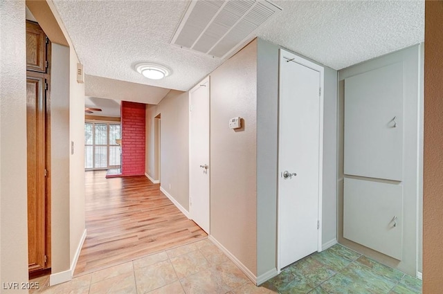 hall with a textured ceiling