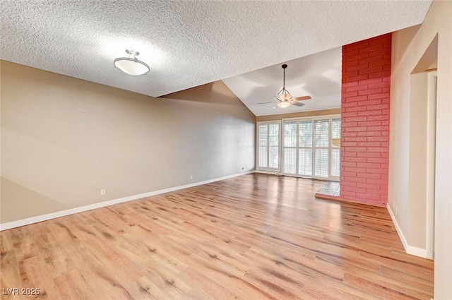 unfurnished living room with a textured ceiling, light wood-type flooring, vaulted ceiling, and ceiling fan