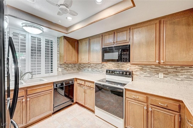 kitchen with tasteful backsplash, ceiling fan, sink, black appliances, and light tile patterned flooring