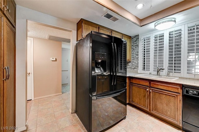 kitchen featuring decorative backsplash, sink, and black appliances