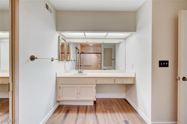 bathroom featuring hardwood / wood-style floors and vanity