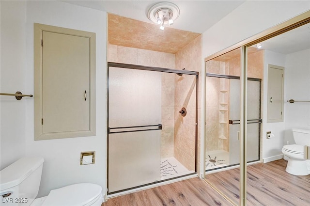 bathroom featuring hardwood / wood-style flooring, toilet, and walk in shower