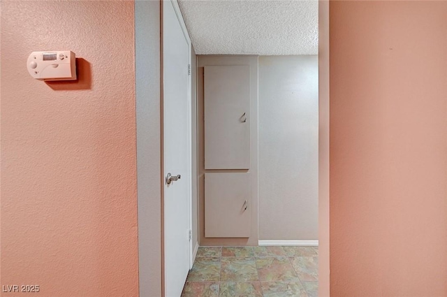 hallway featuring a textured ceiling