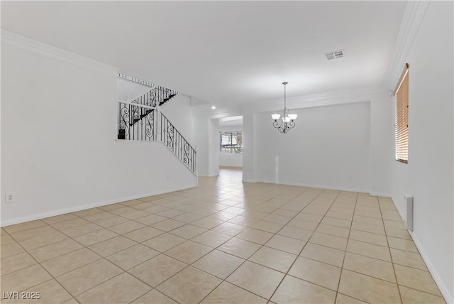 empty room featuring ornamental molding, a chandelier, and light tile patterned floors