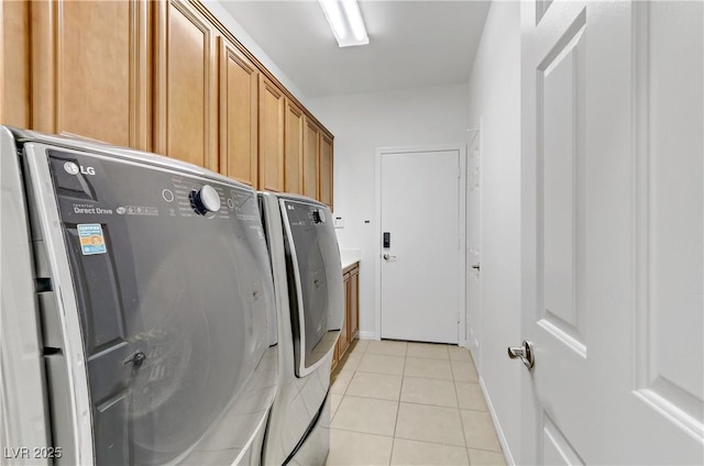 washroom with cabinets, light tile patterned flooring, and independent washer and dryer