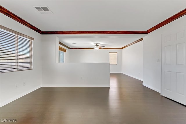 empty room with ceiling fan, ornamental molding, and dark wood-type flooring