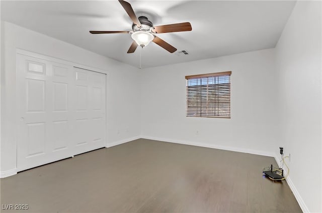 unfurnished bedroom featuring ceiling fan, a closet, and wood-type flooring