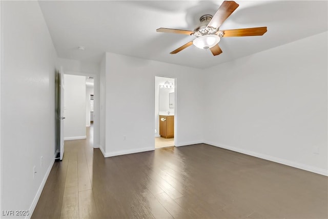 empty room featuring ceiling fan and dark hardwood / wood-style flooring