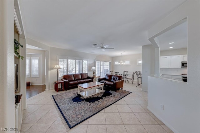 tiled living room with ceiling fan