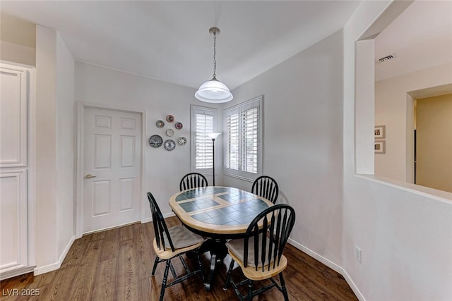 dining area featuring dark hardwood / wood-style floors