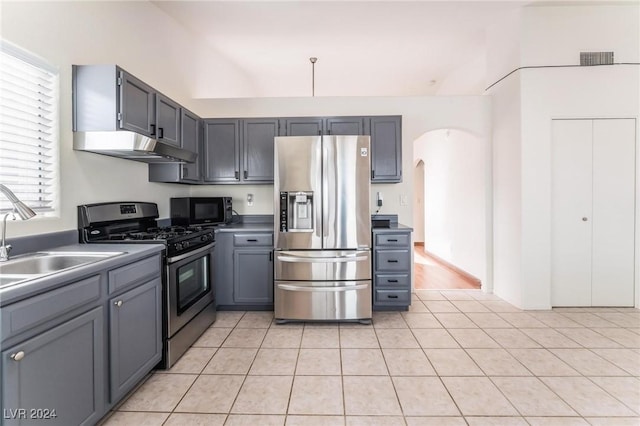 kitchen featuring appliances with stainless steel finishes, sink, gray cabinetry, and light tile patterned flooring