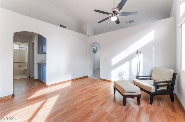 sitting room with light hardwood / wood-style floors, vaulted ceiling, and ceiling fan