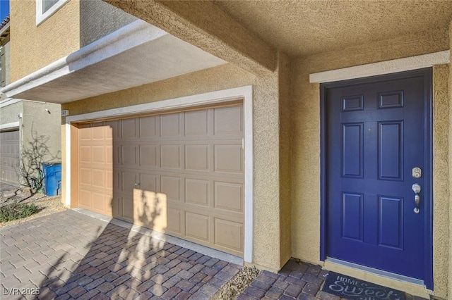 view of exterior entry featuring a garage