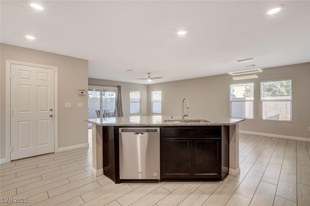 kitchen with ceiling fan, dishwasher, sink, an island with sink, and dark brown cabinets