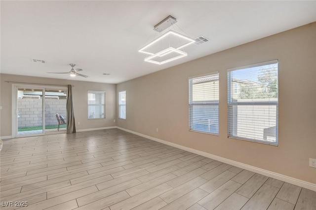 unfurnished room with light wood-type flooring and ceiling fan