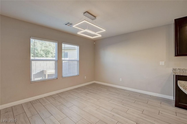 unfurnished dining area with light wood-type flooring