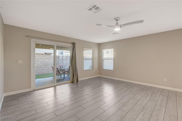 unfurnished room with ceiling fan and plenty of natural light