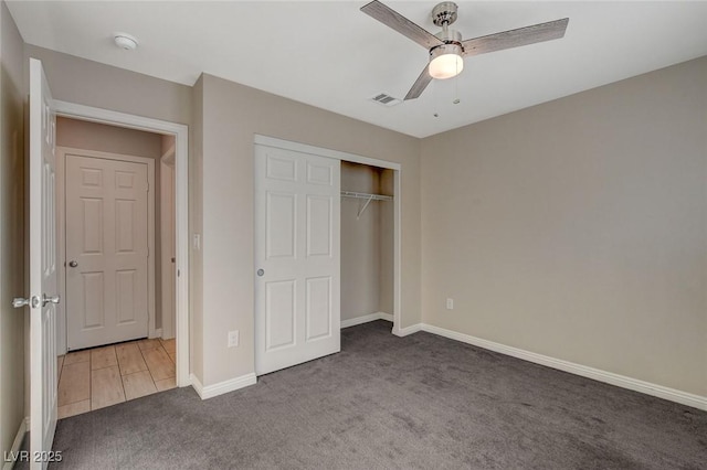 unfurnished bedroom featuring ceiling fan, carpet floors, and a closet