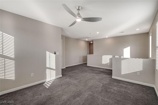 carpeted spare room featuring ceiling fan