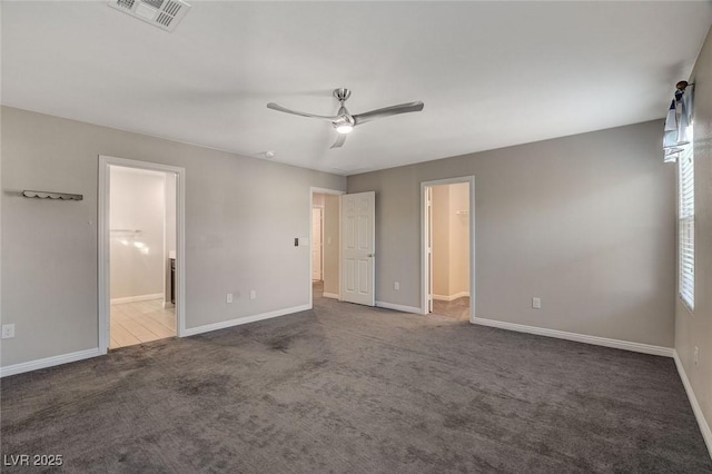 unfurnished bedroom with carpet flooring, ceiling fan, and ensuite bath