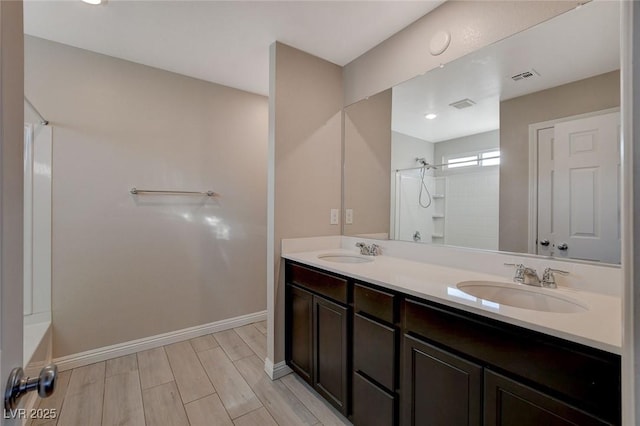 bathroom with vanity, hardwood / wood-style flooring, and  shower combination