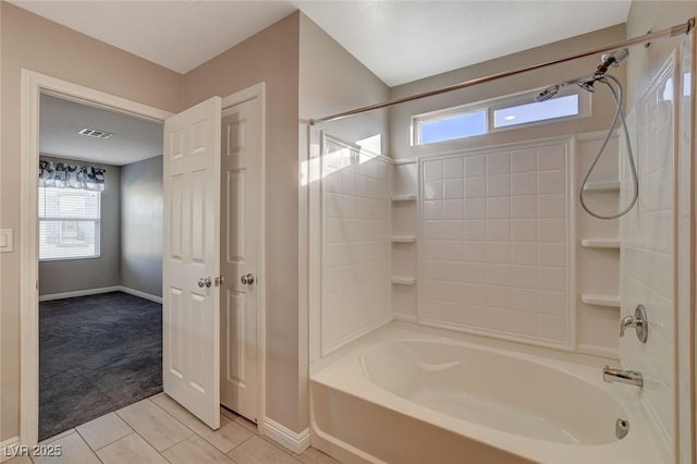 bathroom with washtub / shower combination and tile patterned floors