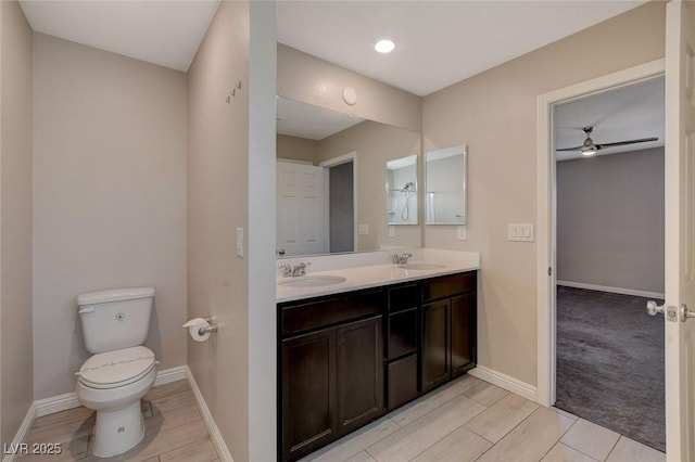 bathroom with ceiling fan, vanity, and toilet