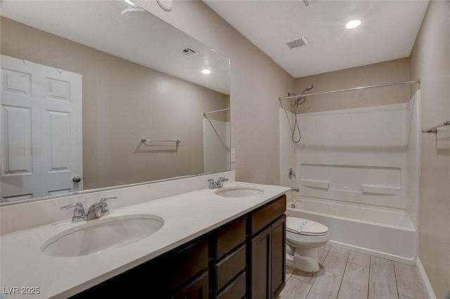 full bathroom featuring vanity, toilet, and shower / tub combination