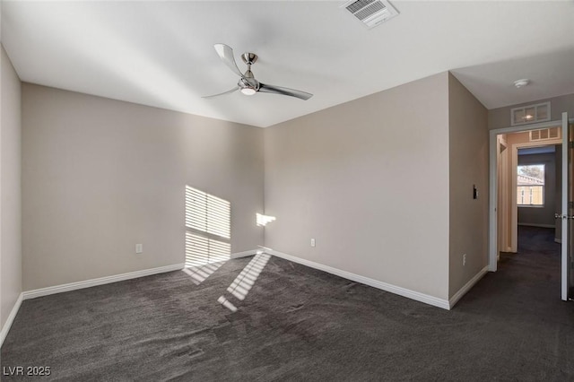 unfurnished room with ceiling fan and dark carpet