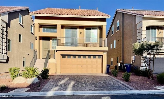 view of front facade with a balcony and a garage