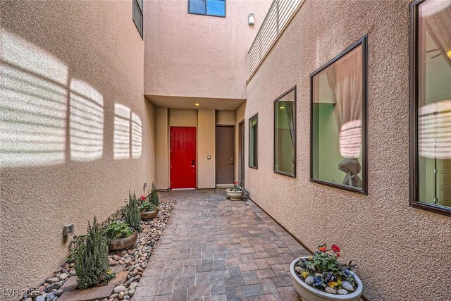 doorway to property with a patio area