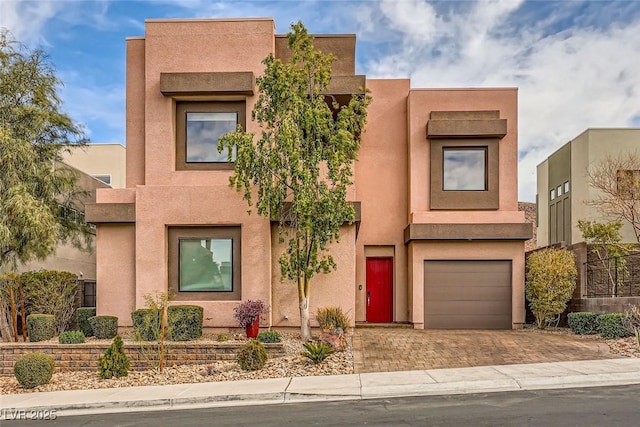 pueblo-style home featuring a garage