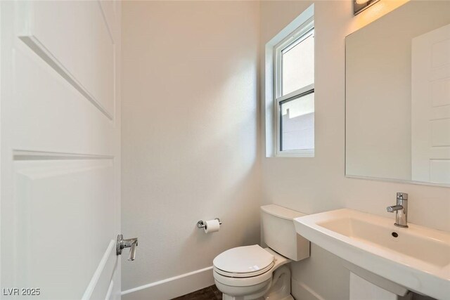 bathroom featuring sink and toilet