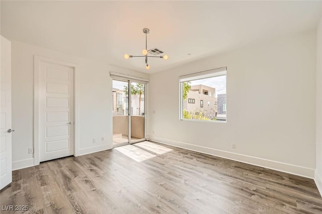 unfurnished bedroom featuring wood-type flooring and access to outside