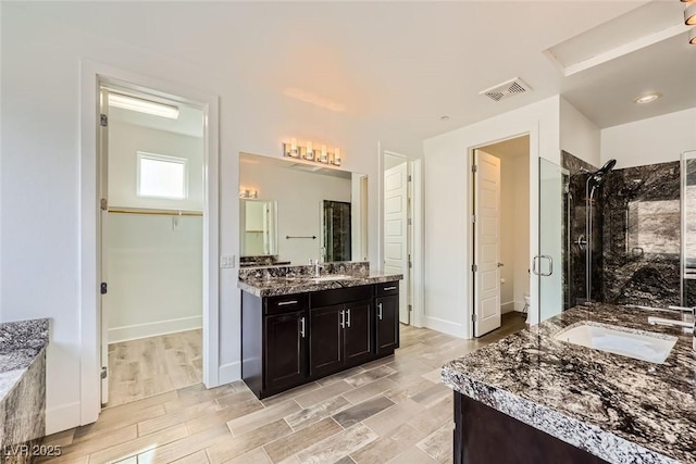 bathroom with vanity and walk in shower