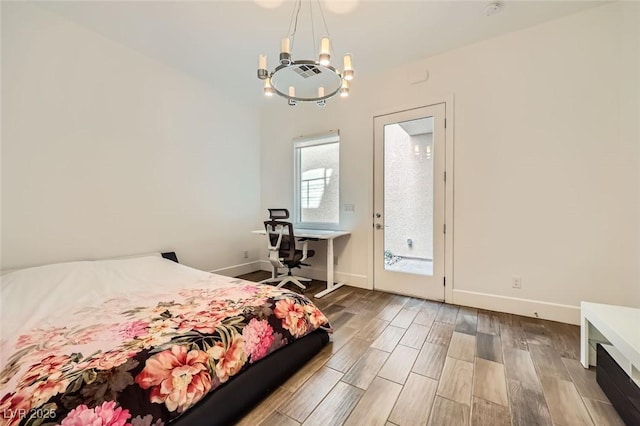 bedroom with a chandelier and access to outside