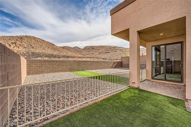 view of yard with a mountain view and a patio area