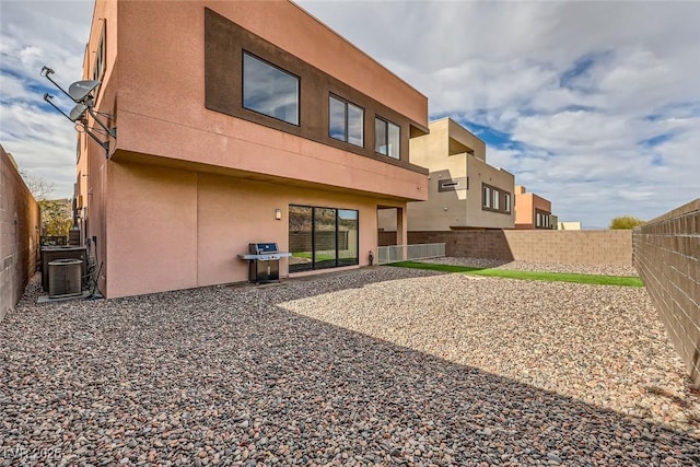 back of property with cooling unit and a patio