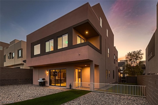 view of back house at dusk