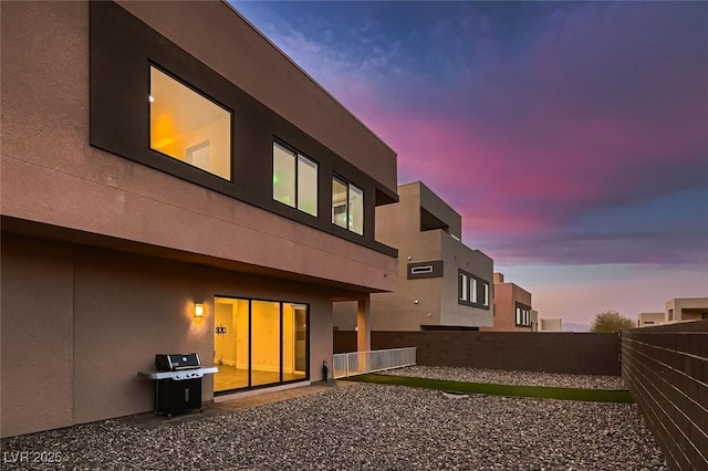 view of back house at dusk