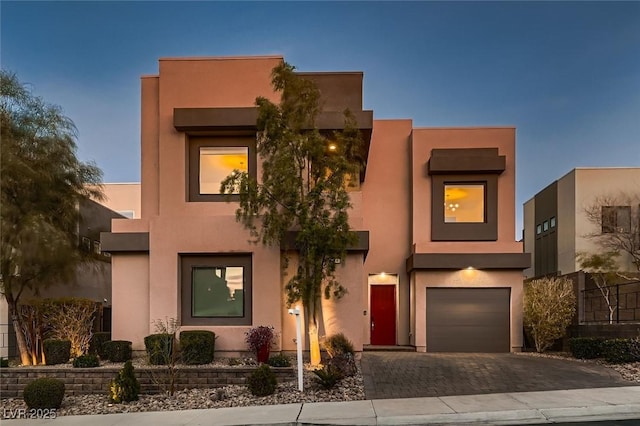 pueblo revival-style home featuring a garage